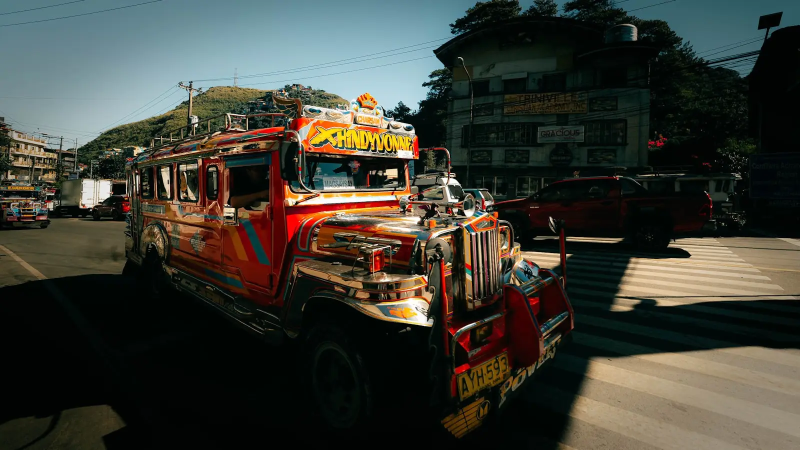A jeepney on a Philippine street in daylight, passengers aboard.
